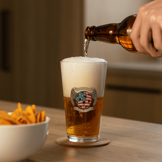 Pouring beer into The American Dream Pickleball Shaker Pint Glass with chips on the table.