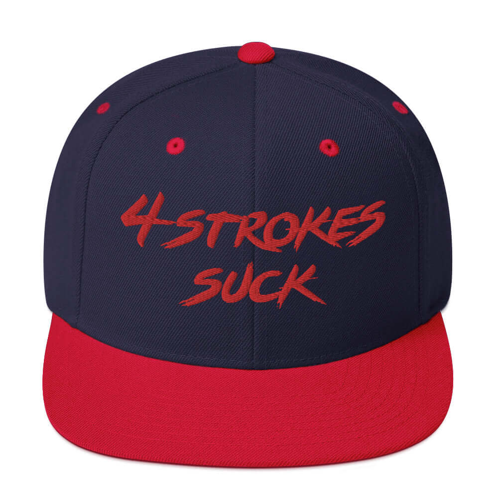 Embroidered "4-Strokes Suck" snapback hat in navy and red colors, celebrating motocross and the rebellious spirit of Ronnie Mac.