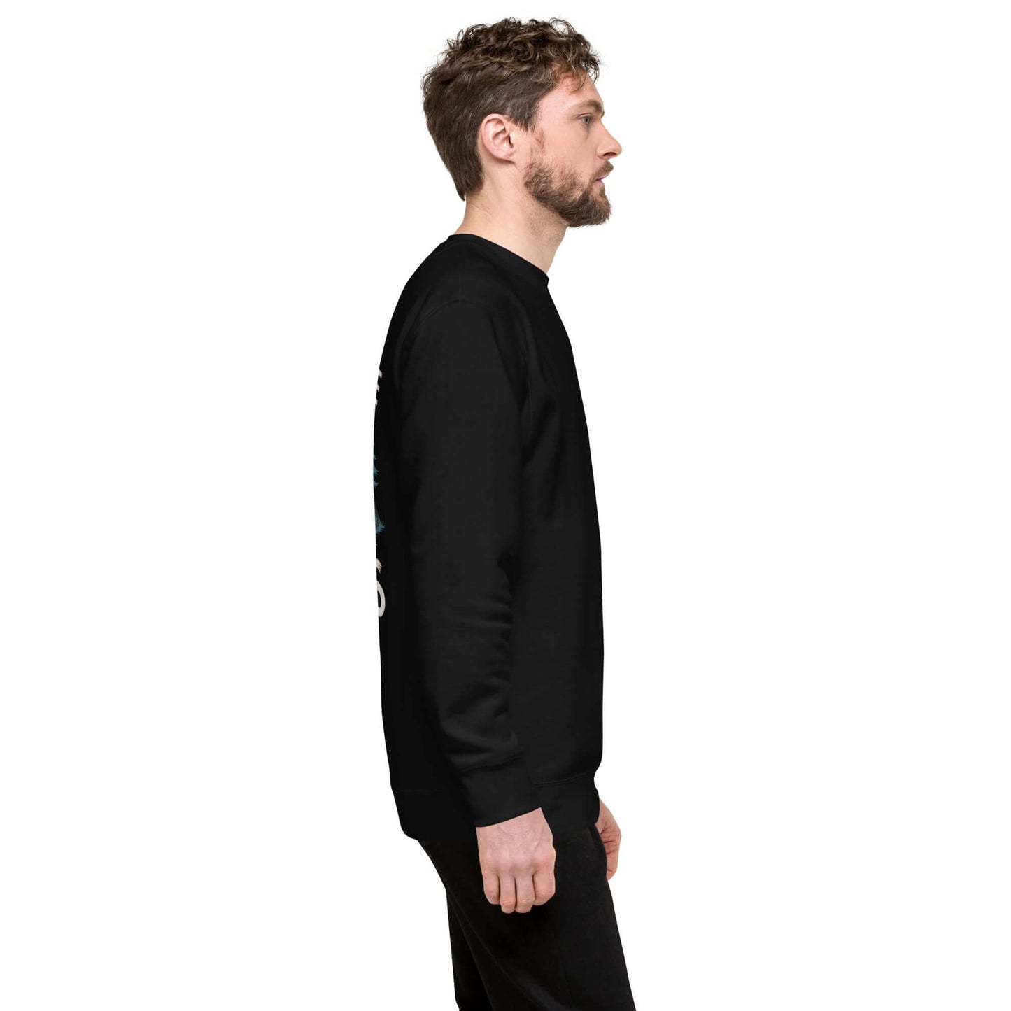 Side view of an adult man wearing a black premium sweatshirt, showcasing its classic design and long sleeves.
