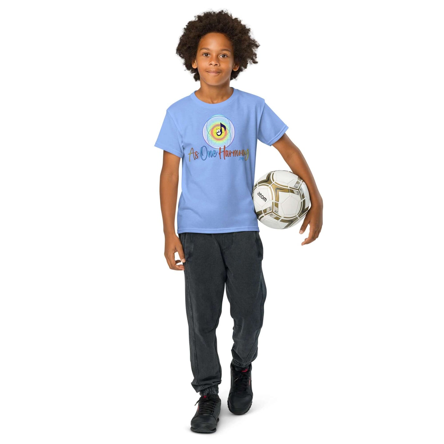 Youth in blue moisture-wicking t-shirt, playing soccer, showcasing active lifestyle and comfort.