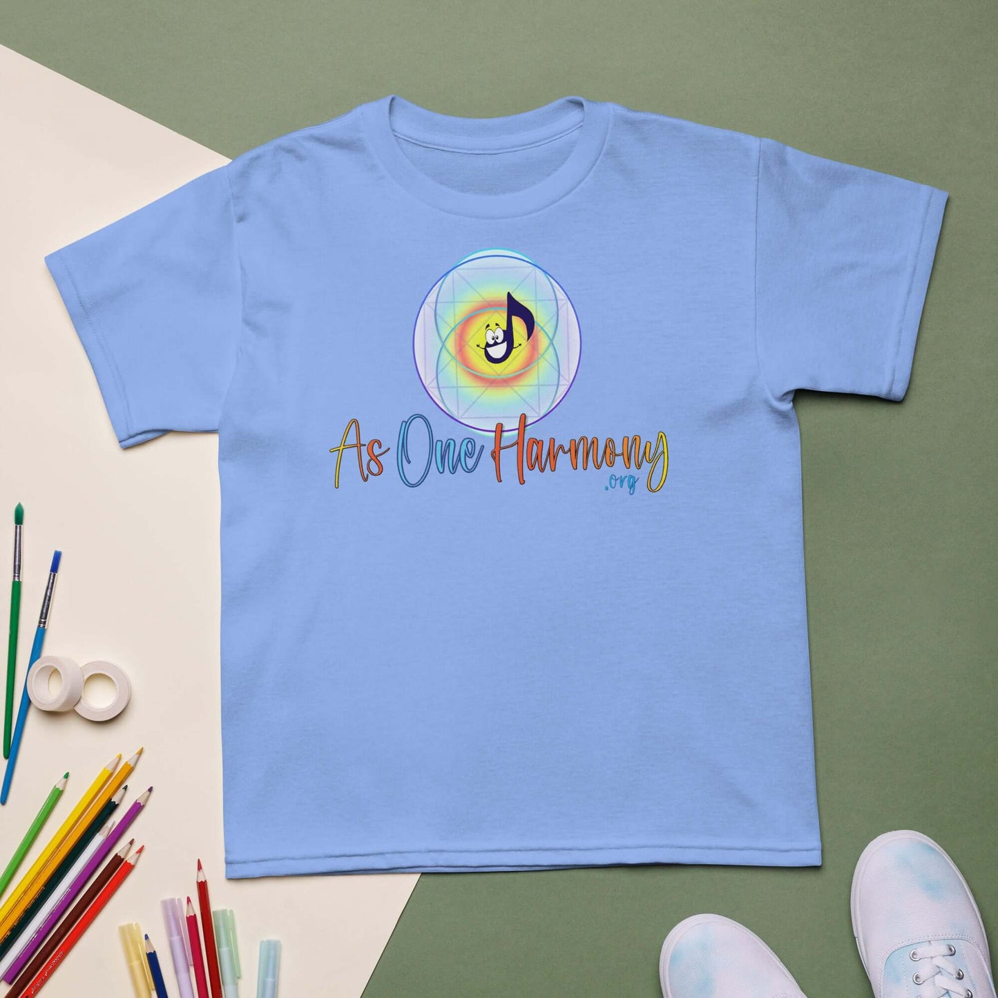 Light blue moisture-wicking t-shirt for kids with 'As One Harmony' graphic and music note design.