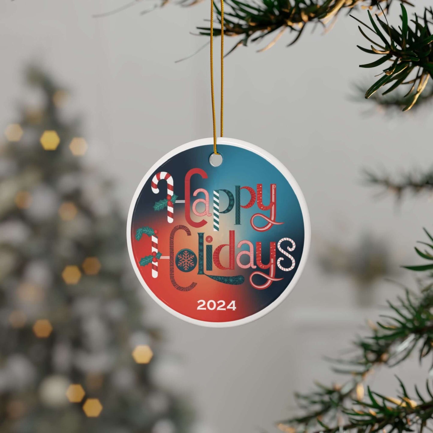 Ceramic ornament with "Happy Holidays" design, festive symbols, and 2024 date, hanging on a Christmas tree with blurred lights.