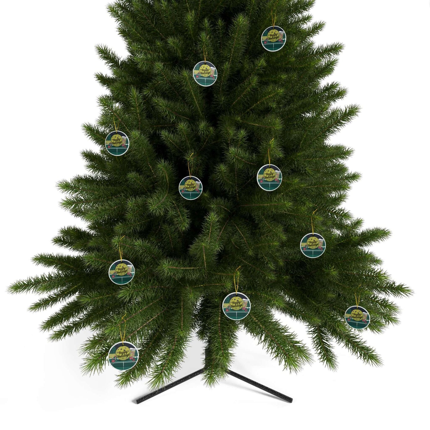 Christmas tree decorated with Pickleball Holiday Cheer Court Ceramic Ornaments featuring festive illustrations and "Happy Holidays" text.