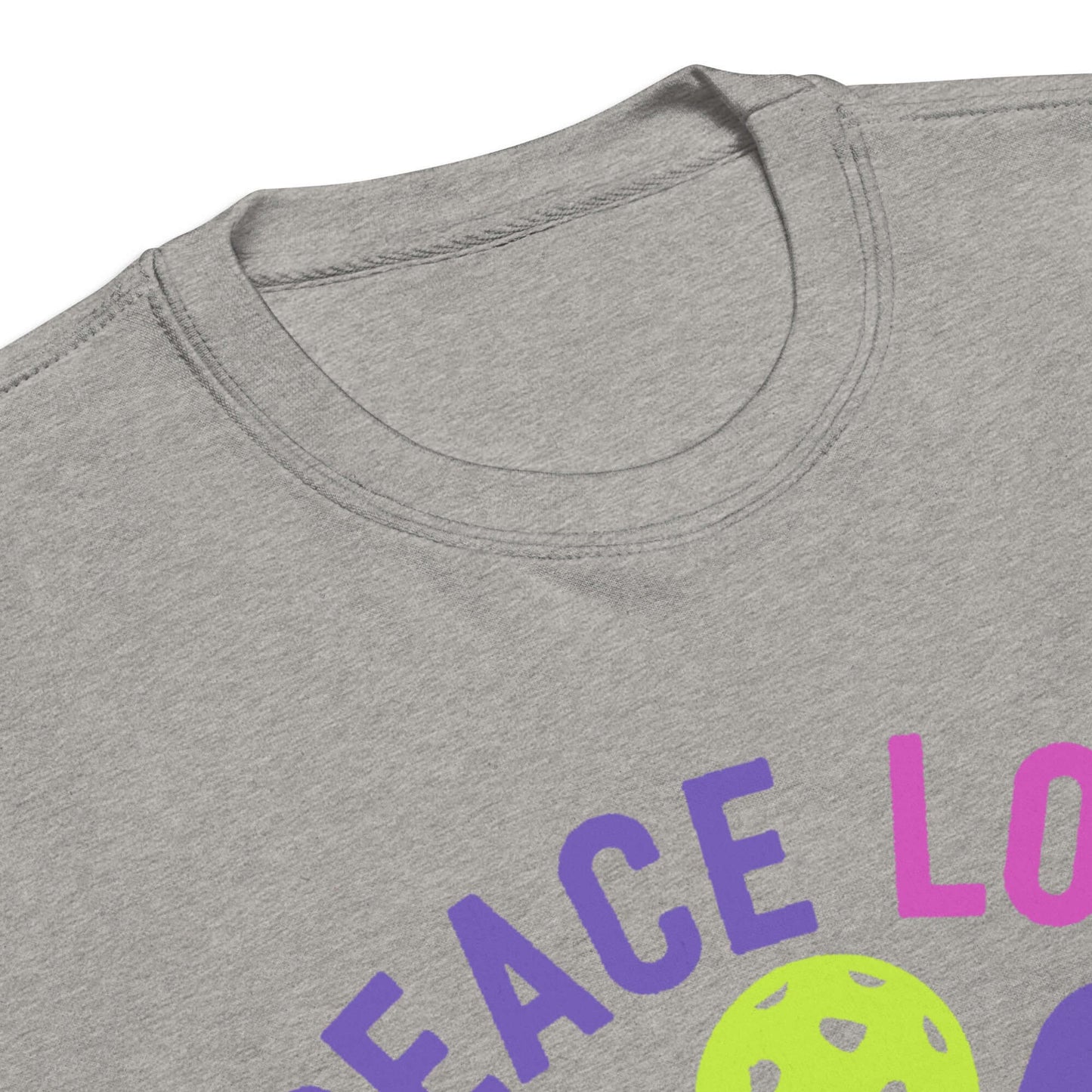 Close-up of the neckline of a gray women's sweatshirt featuring the text 'Peace, Love, Pickleball' and pickleball graphic.