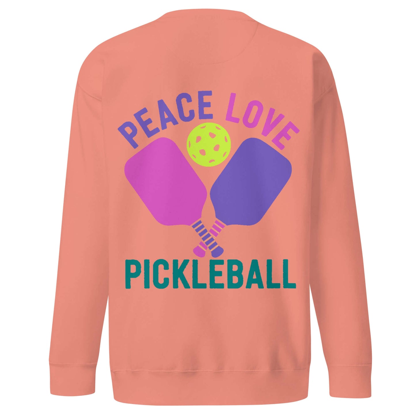 Women's peach sweatshirt with 'Peace Love Pickleball' graphic and paddles, perfect for pickleball enthusiasts.