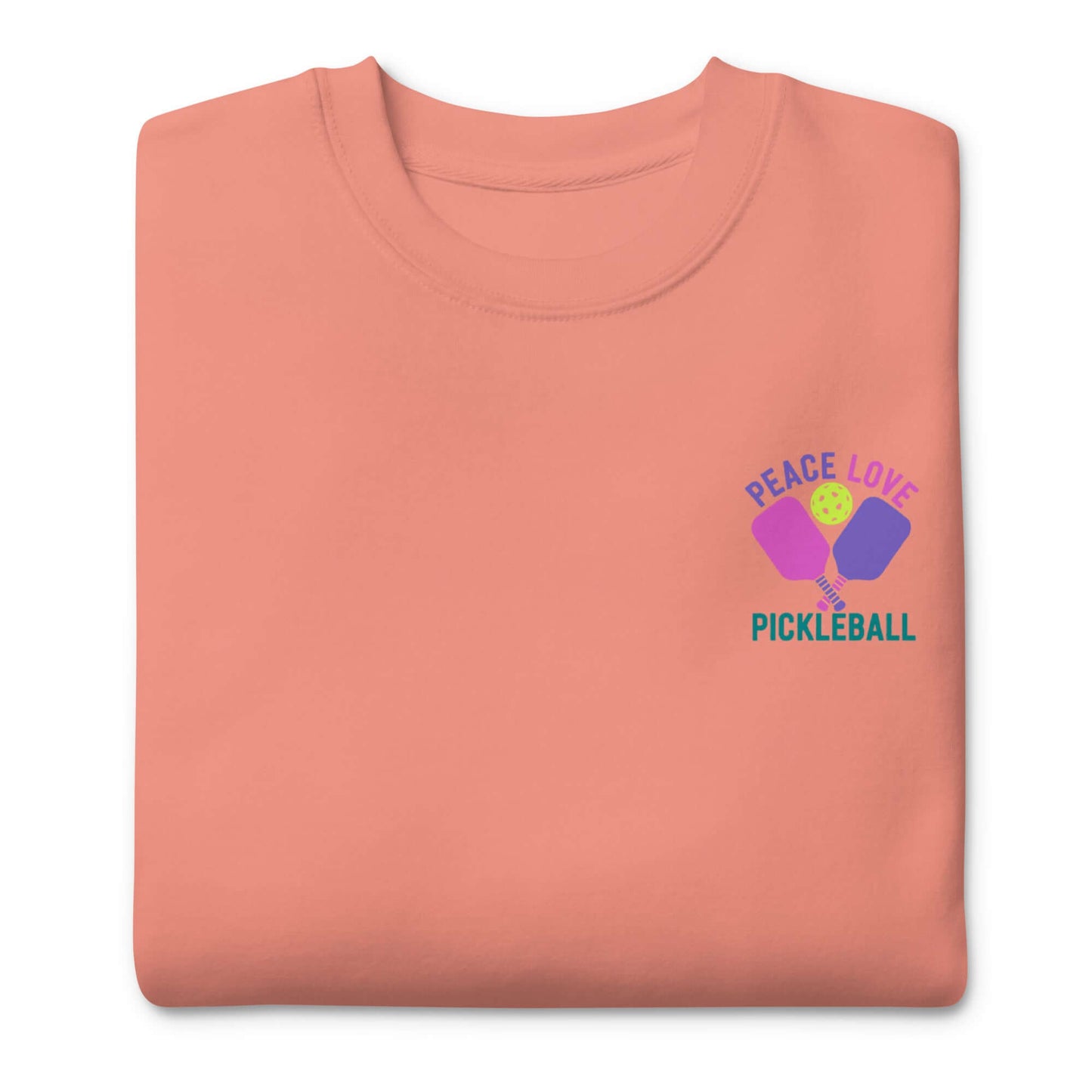 Women's coral sweatshirt featuring 'Peace, Love, Pickleball' graphic for pickleball enthusiasts.