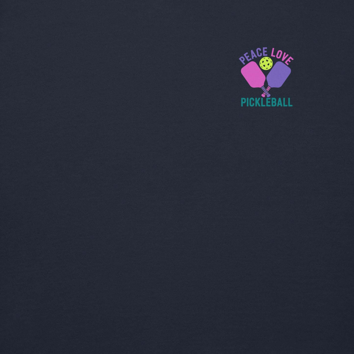 Close-up of the Peace Love Pickleball logo on a dark sweatshirt, featuring vibrant colors and a playful design.
