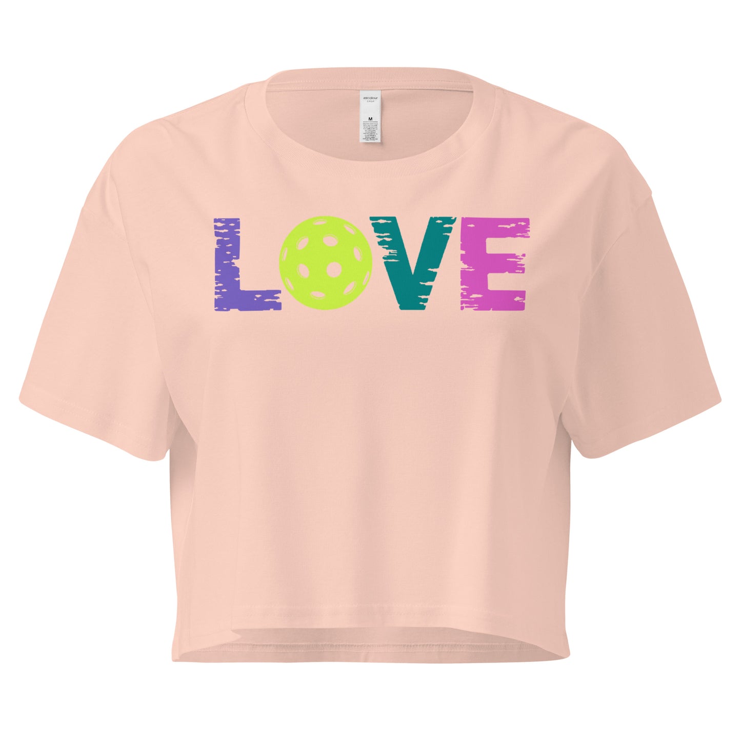 Women’s LOVE Pickleball Crop Top in peach with vibrant multicolored text and pickleball graphic design.
