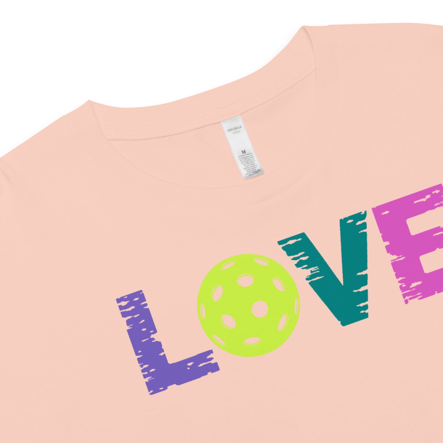 Women's LOVE Pickleball Crop Top featuring vibrant colors and playful pickleball graphic on soft fabric.