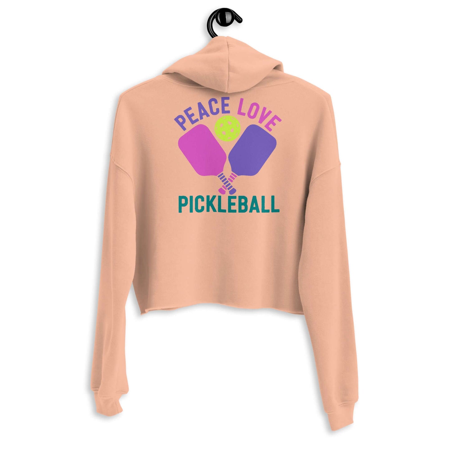 Back view of Women's Peace, Love, Pickleball Crop Hoodie with colorful design on a hanger.