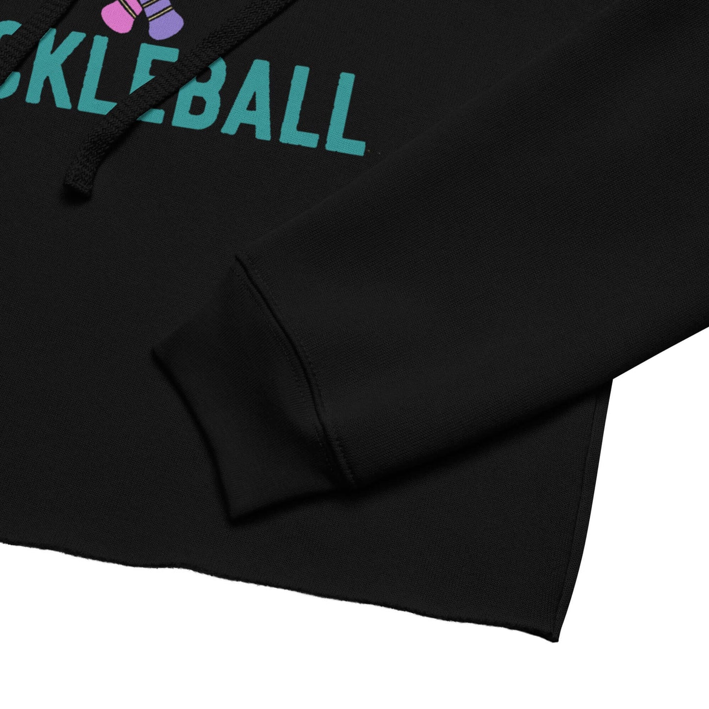 Close-up of Women's Peace, Love, Pickleball Crop Hoodie showcasing black fabric and vibrant pickleball graphics.