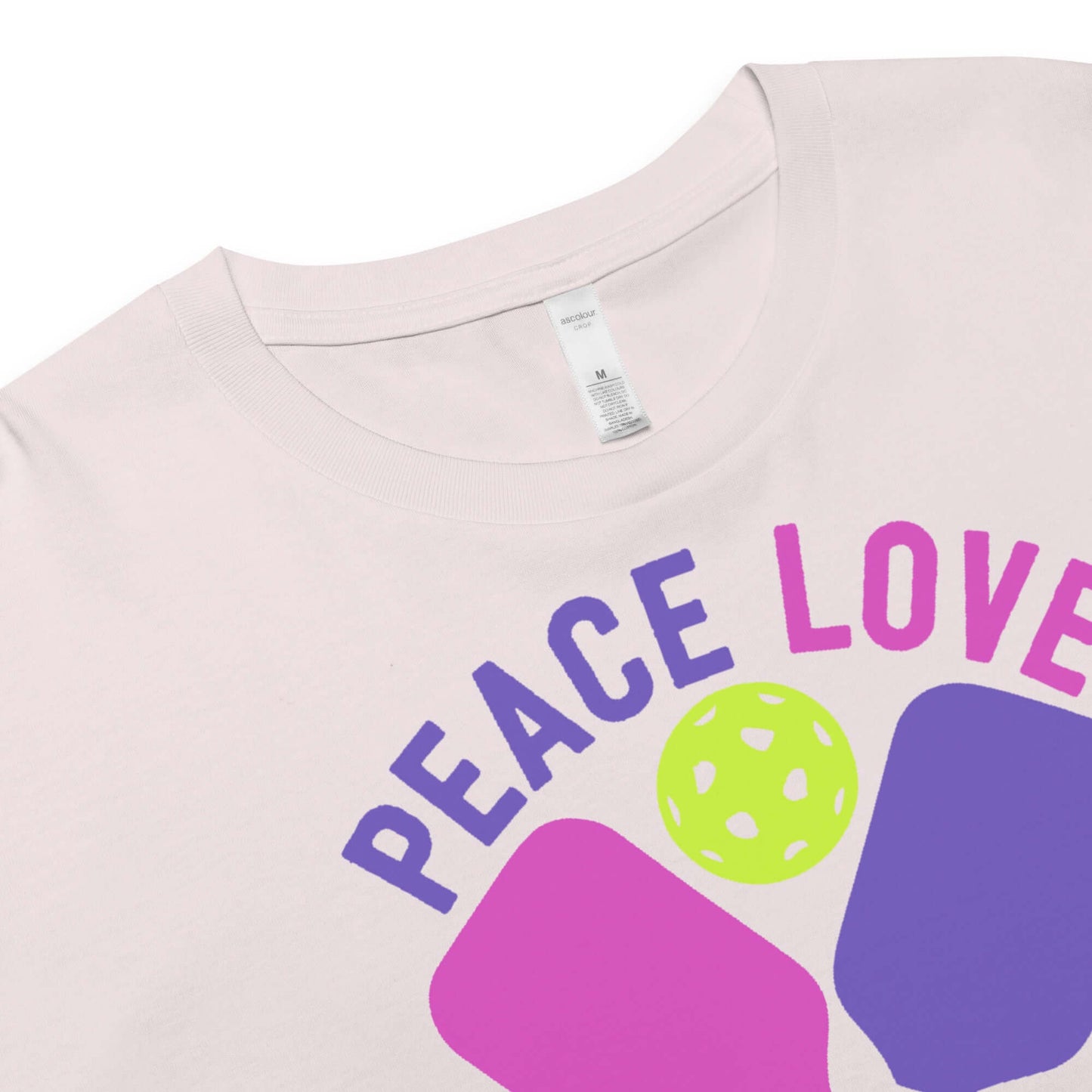 Close-up of Women's Peace, Love, Pickleball Crop Top with vibrant design featuring paddles and a ball.