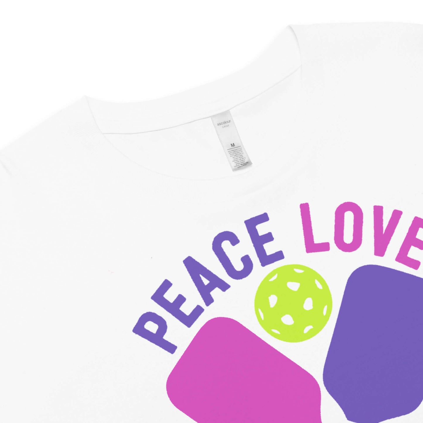 Close-up of Women's Peace, Love, Pickleball Crop Top with vibrant graphic design.