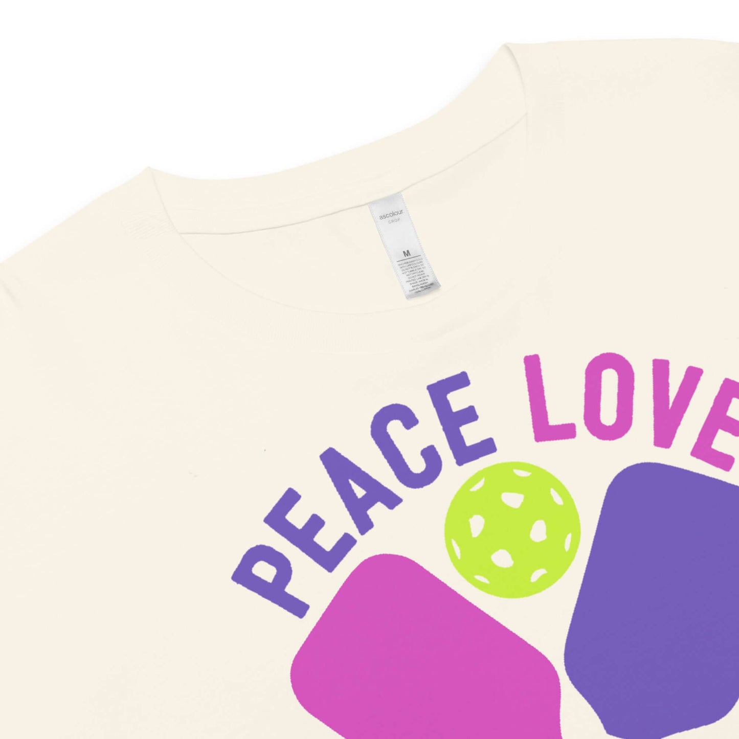 Close-up of Women's Peace, Love, Pickleball Crop Top featuring vibrant design and soft fabric.