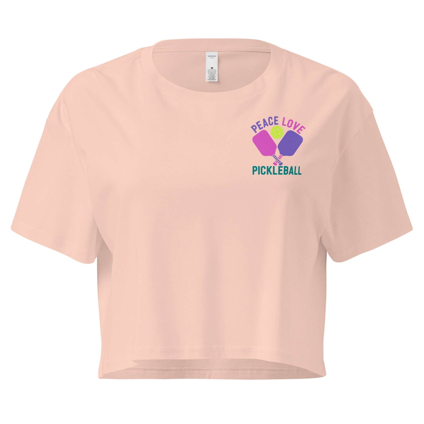 Women's peach crop top featuring 'Peace Love Pickleball' graphic design.