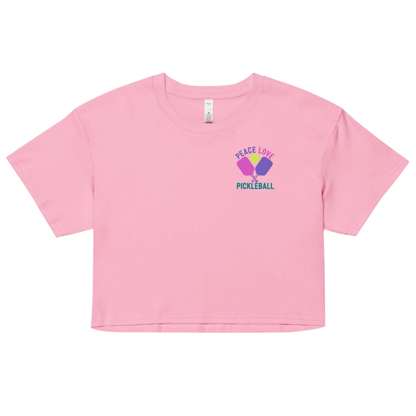 Women's pink crop top with 'Peace Love Pickleball' graphic, perfect for stylish pickleball enthusiasts.
