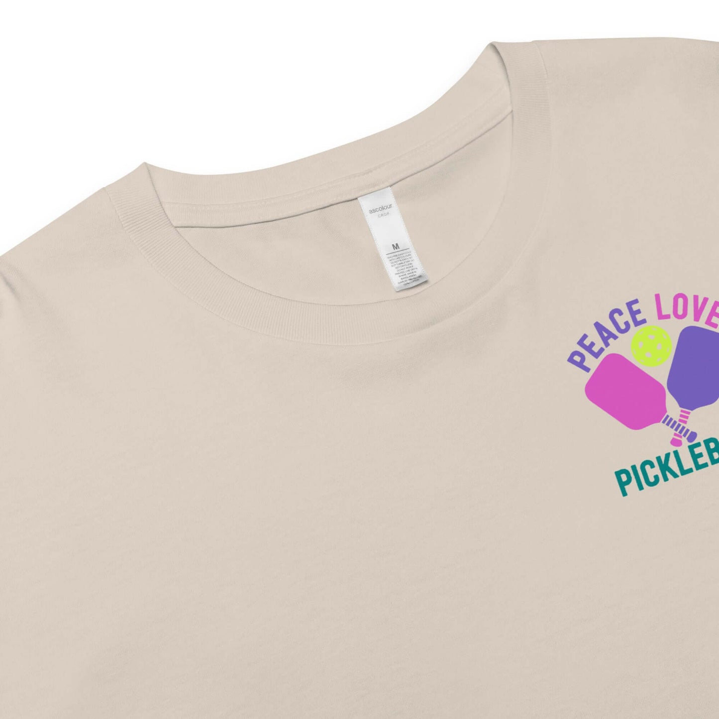 Women's beige crop top featuring a colorful 'Peace Love Pickleball' graphic design.