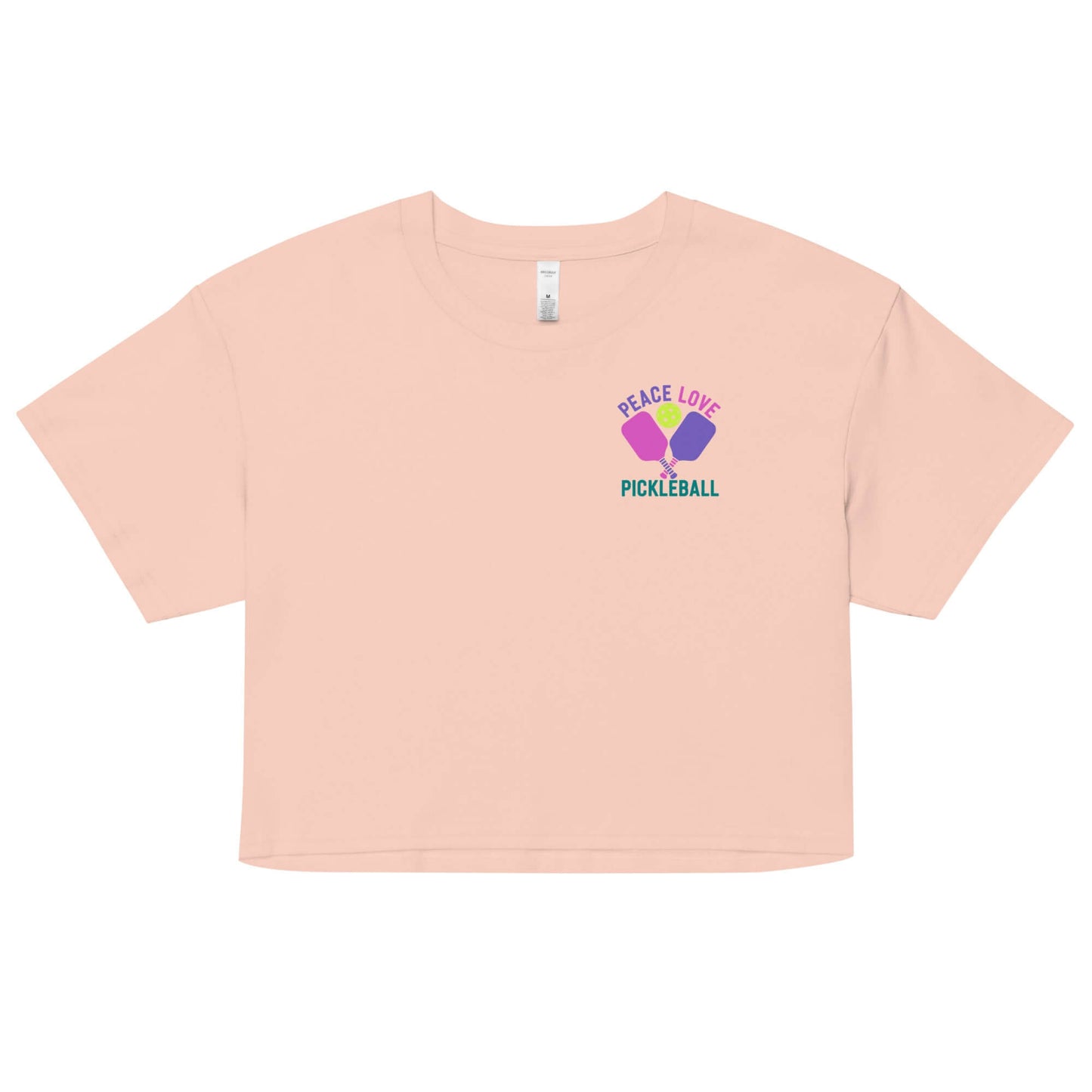Women's Peace Love Pickleball Crop Top in peach with vibrant graphic design.