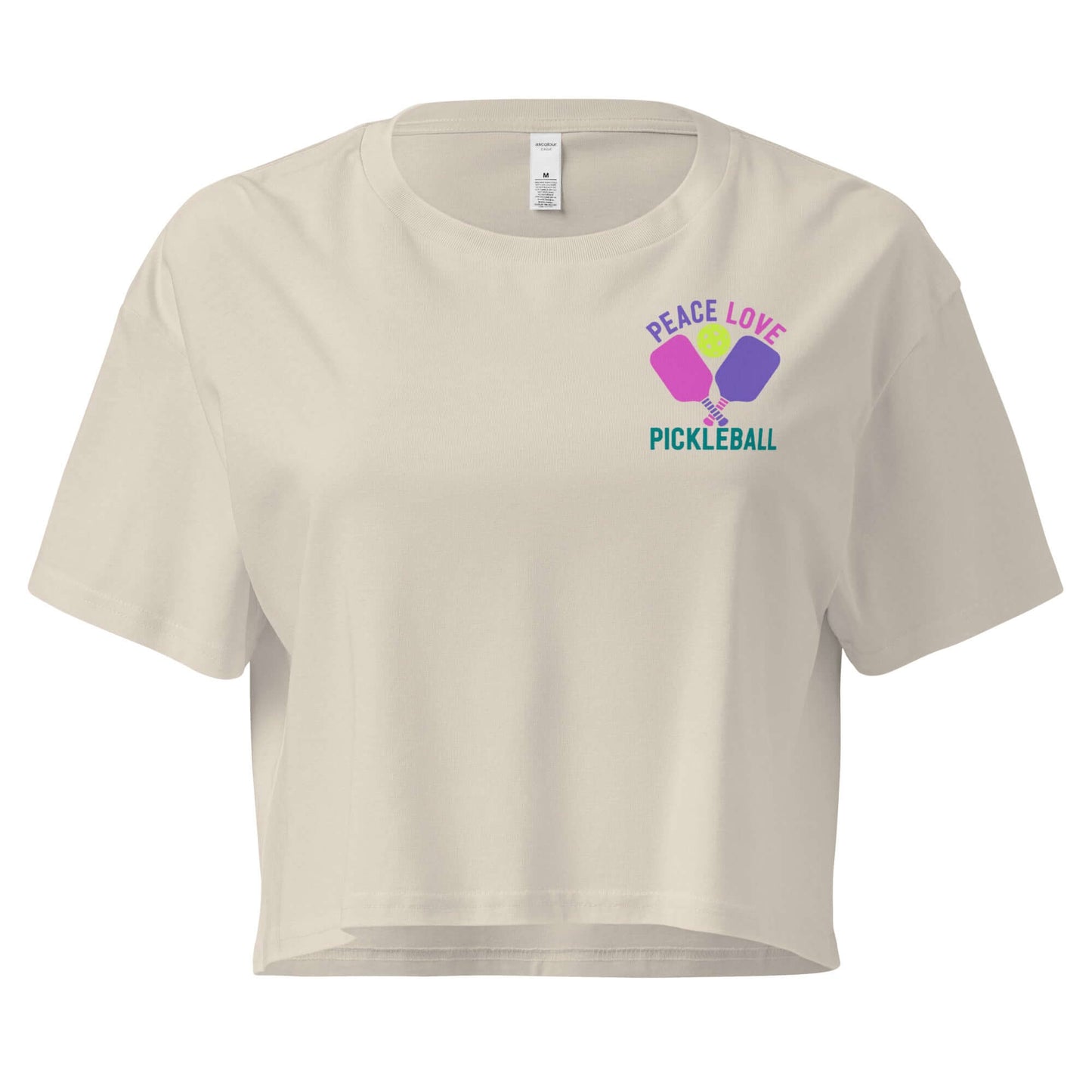 Women's Peace Love Pickleball crop top in cream, featuring graphic design with pickleball paddles.