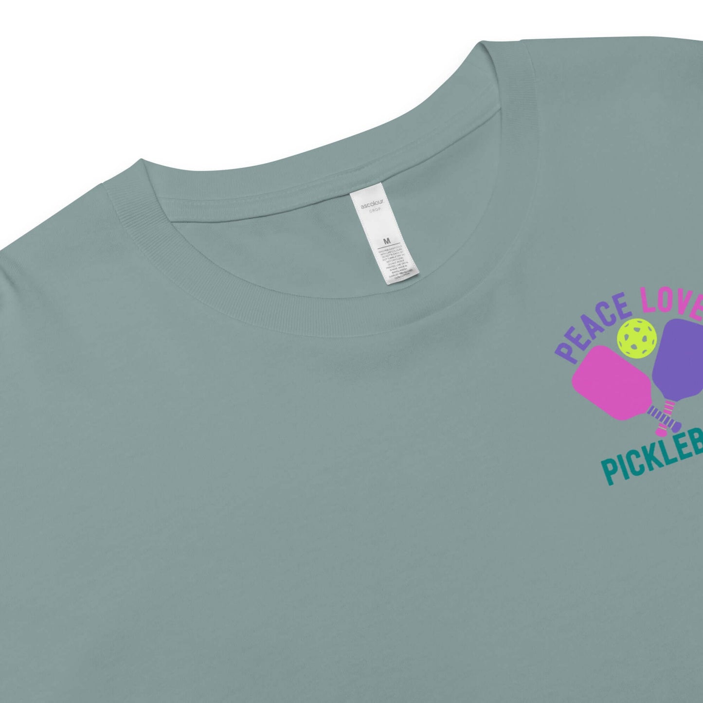 Women's Peace, Love, Pickleball Crop Top in teal with colorful graphic design.