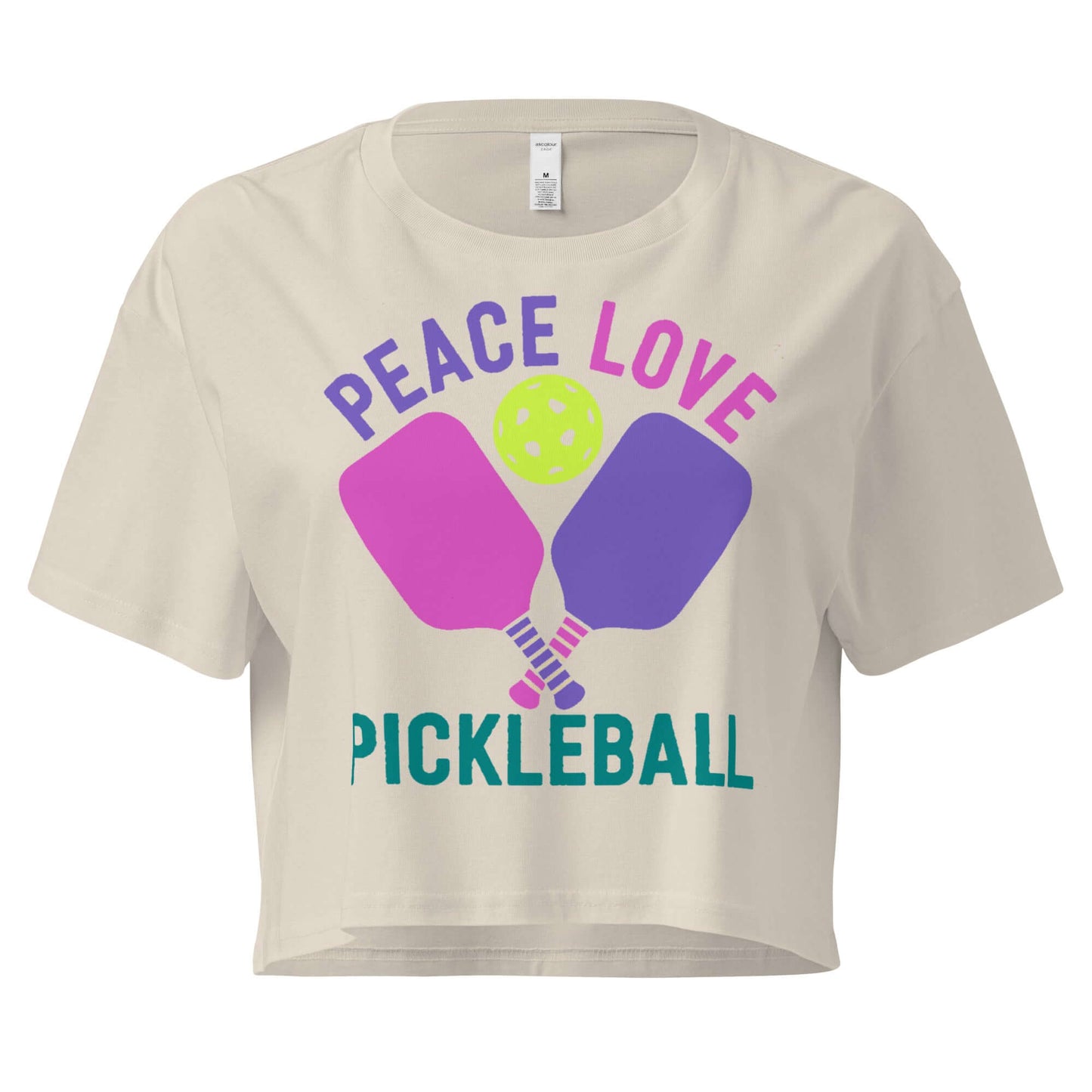 Women's cream crop top featuring 'Peace Love Pickleball' design with paddles and ball.