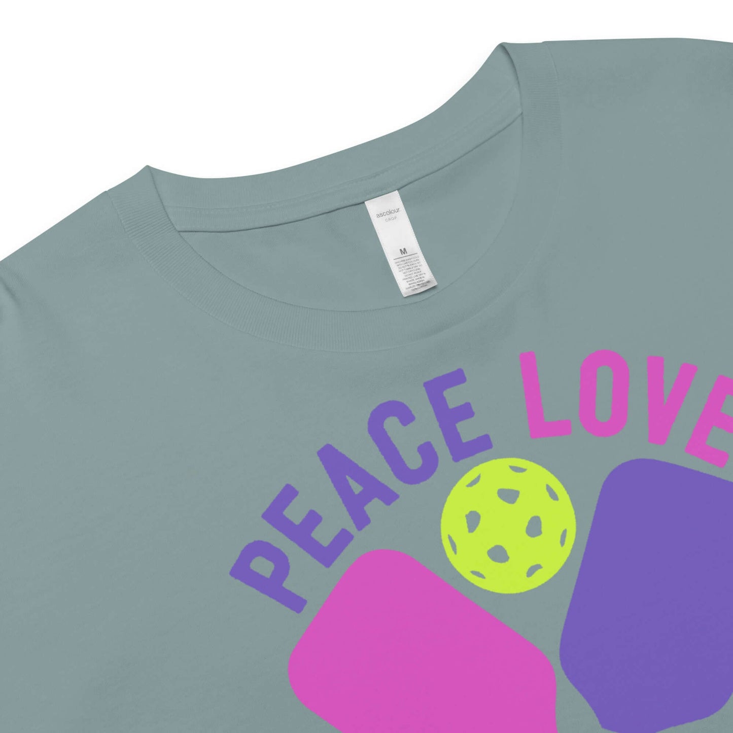 Close-up of Women's Peace, Love, Pickleball Crop Top showcasing vibrant design with pickleball and text.