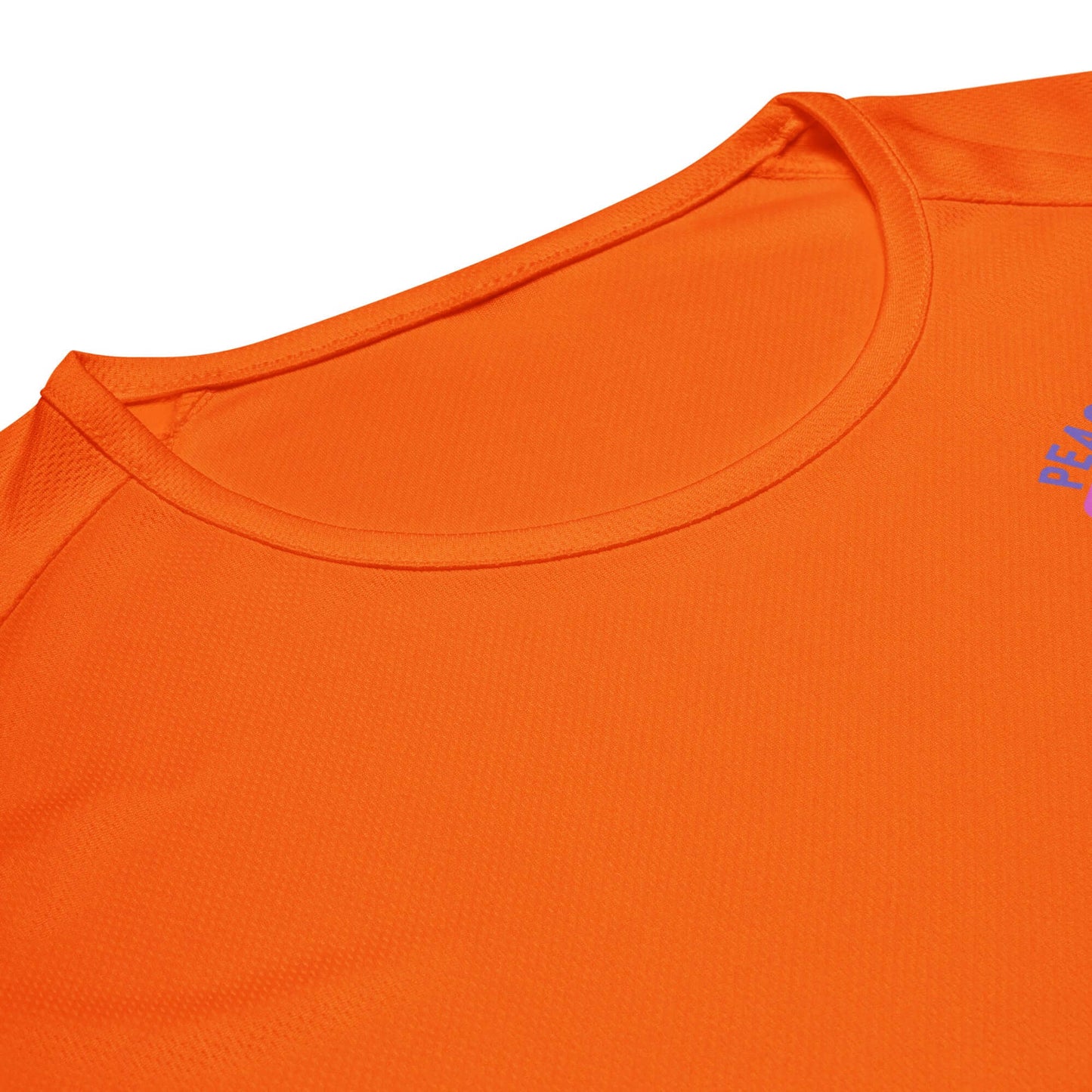 Close-up of women's orange pickleball performance shirt featuring a round neckline and breathable fabric.