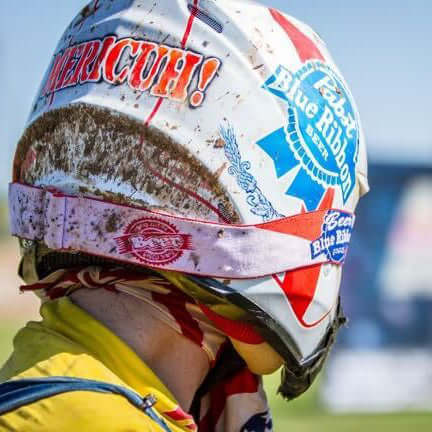 Person wearing colorful helmet and Blue Ribbon Goggles designed for comfort and protection in sports activities.