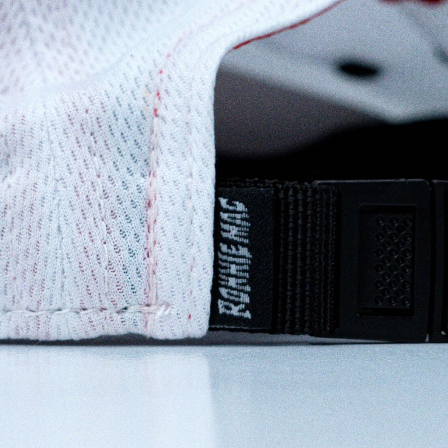 Close-up of adjustable strap on Blue Ribbon Camper Hat with micromesh fabric, featuring the original Ron's Blue Ribbon logo.