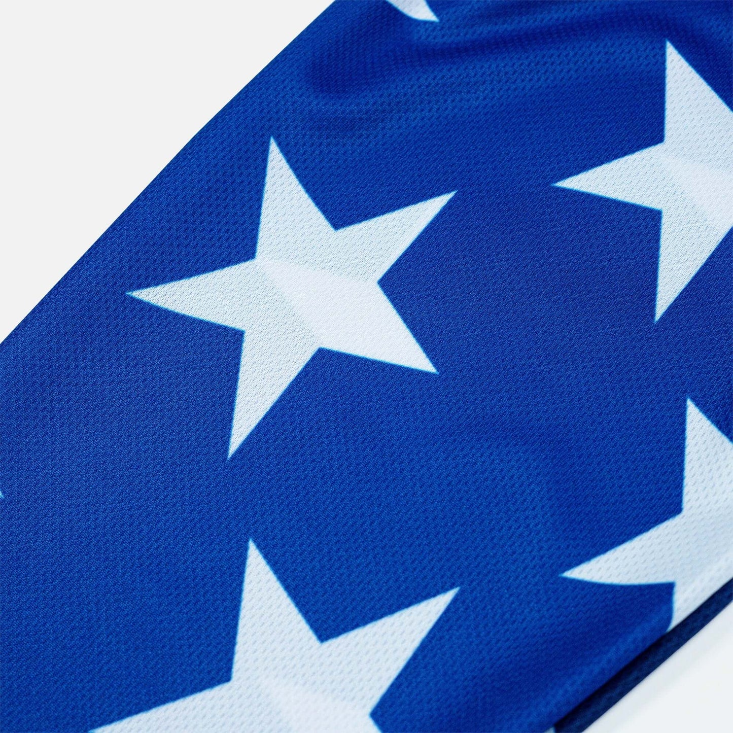 Blue Crossbones Merica Jersey fabric with white stars pattern, showcasing vented polyester mesh texture.