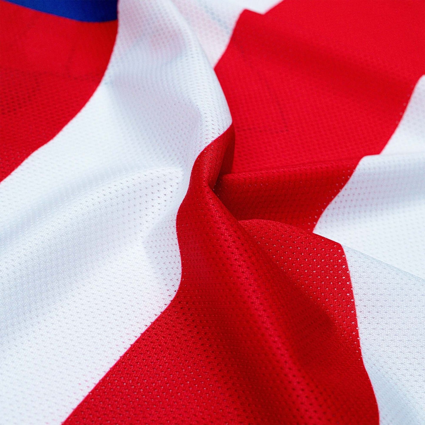 Red and white vented polyester mesh fabric of Crossbones Merica Jersey, showcasing breathable sportswear material.