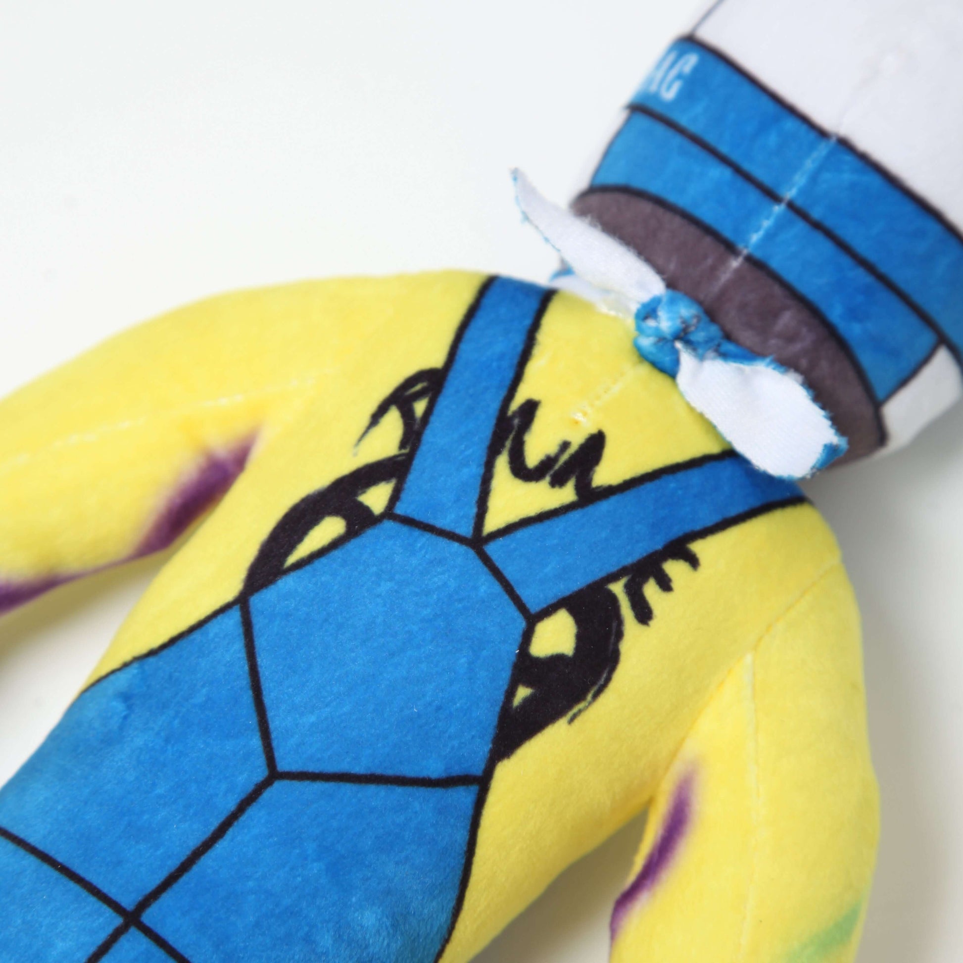 "Lil Ronnie Plush wearing blue overalls and a yellow shirt, cute and mischievous character design."