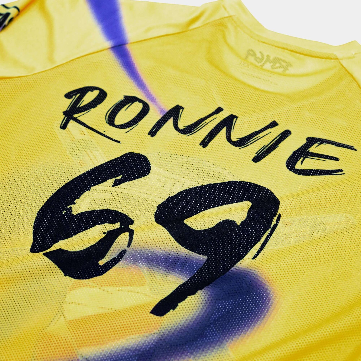 Yellow Crossbones Helmet 69 Jersey with "Ronnie 69" printed in bold black letters.