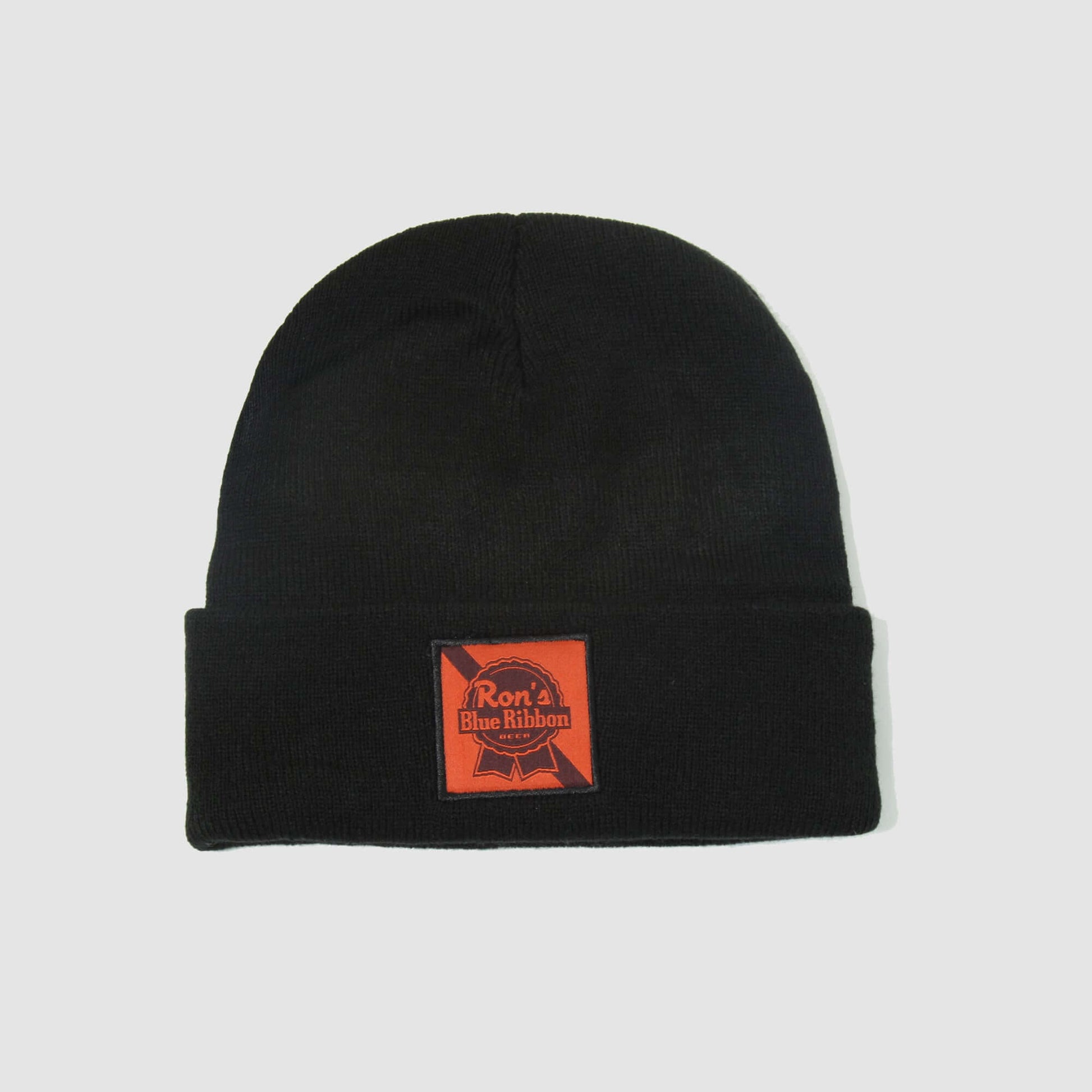 Ron's Blue Ribbon Beer black beanie, perfect for motocross enthusiasts, featuring a rugged patch design on the front.