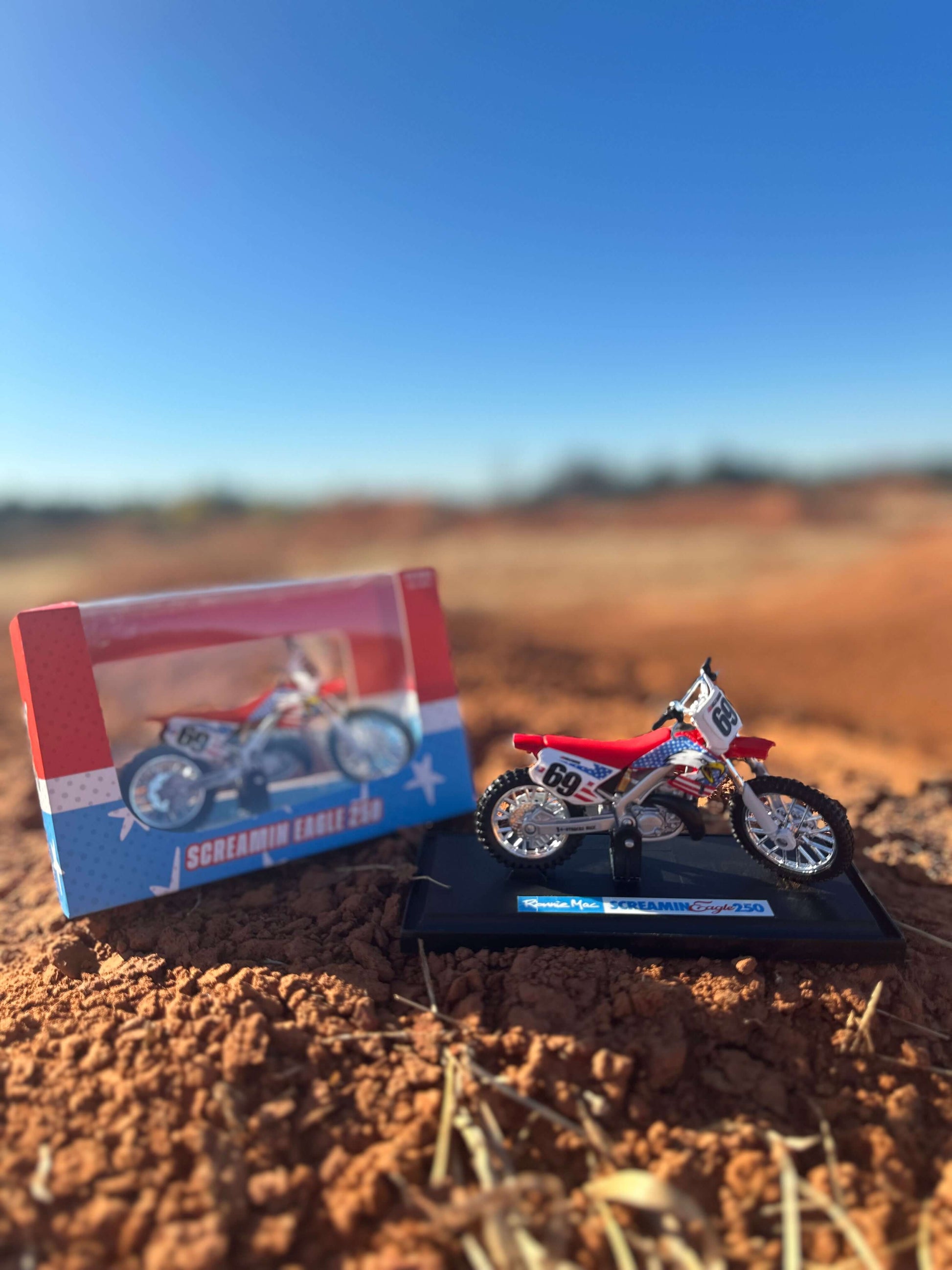 Screamin Eagle 250 Replica Collectible Dirt Bike with Packaging on Dirt Track Background