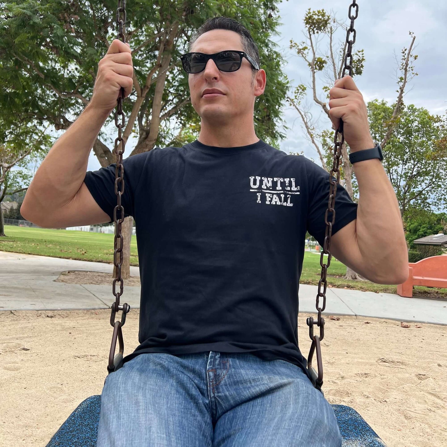 Person wearing Until I Fall Pickleball Black T-Shirt on a swing, embodying the spirit of perseverance and determination.