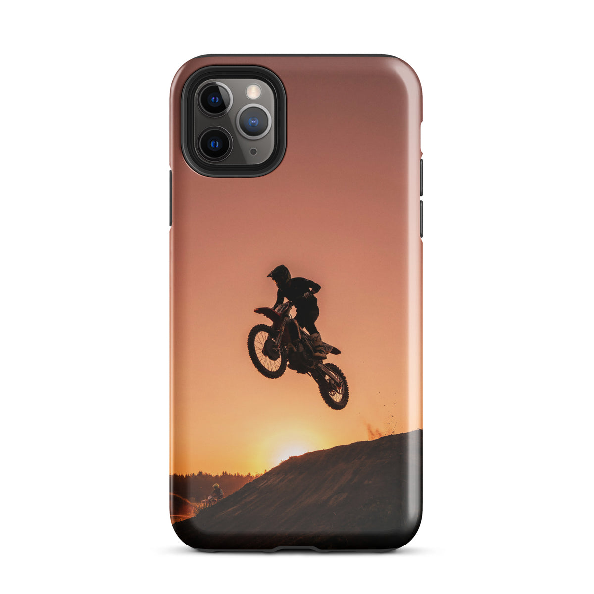 Phone Case for iPhone featuring motocross sunset dirt bike design with dramatic jump against a copper and burnt orange sky.