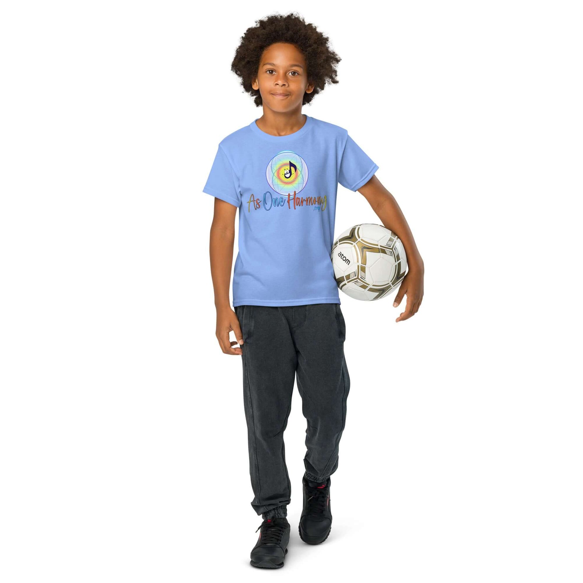 Youth in blue moisture-wicking t-shirt, playing soccer, showcasing active lifestyle and comfort.