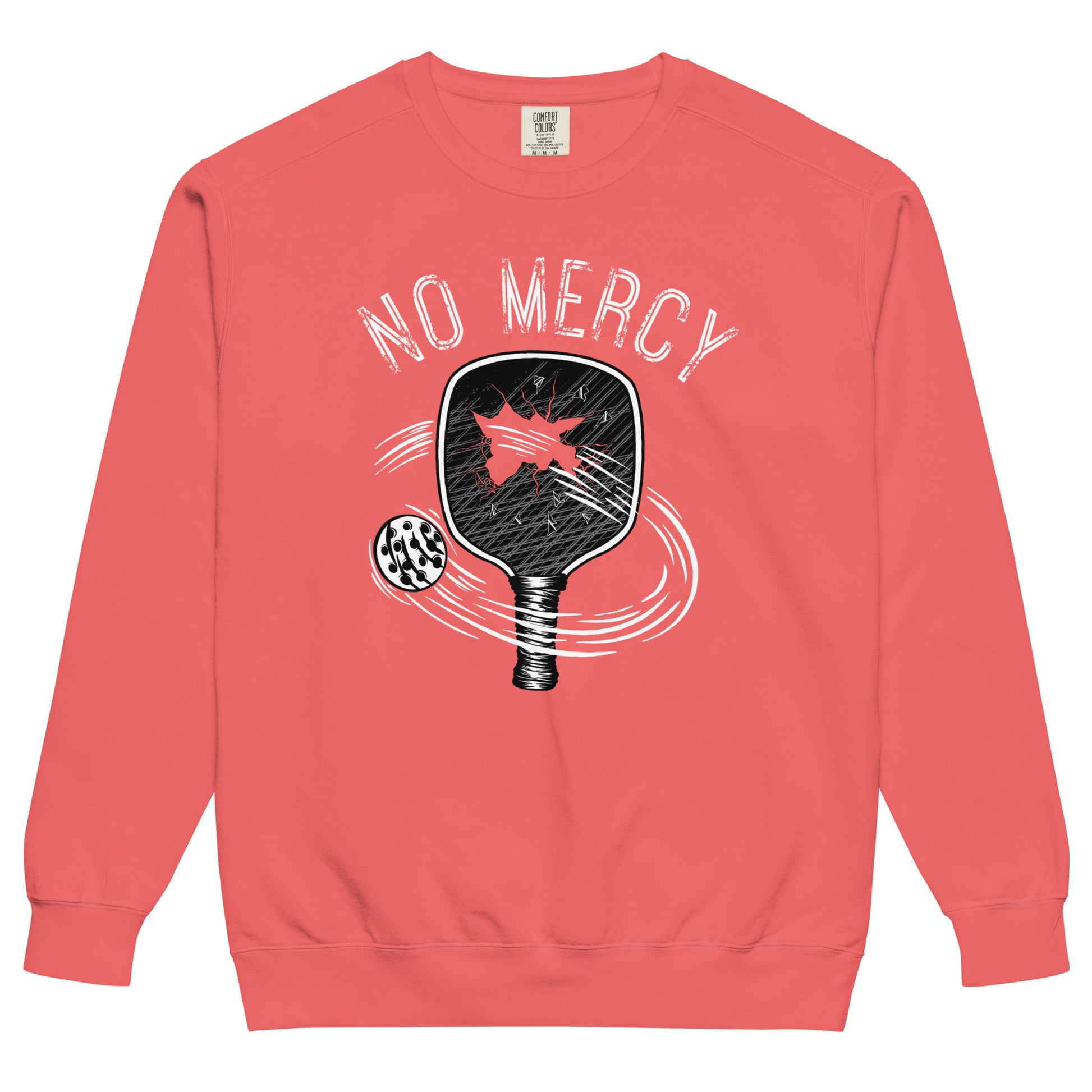 Pickleball No Mercy Series unisex garment-dyed sweatshirt in coral with graphic design of a paddle and ball.