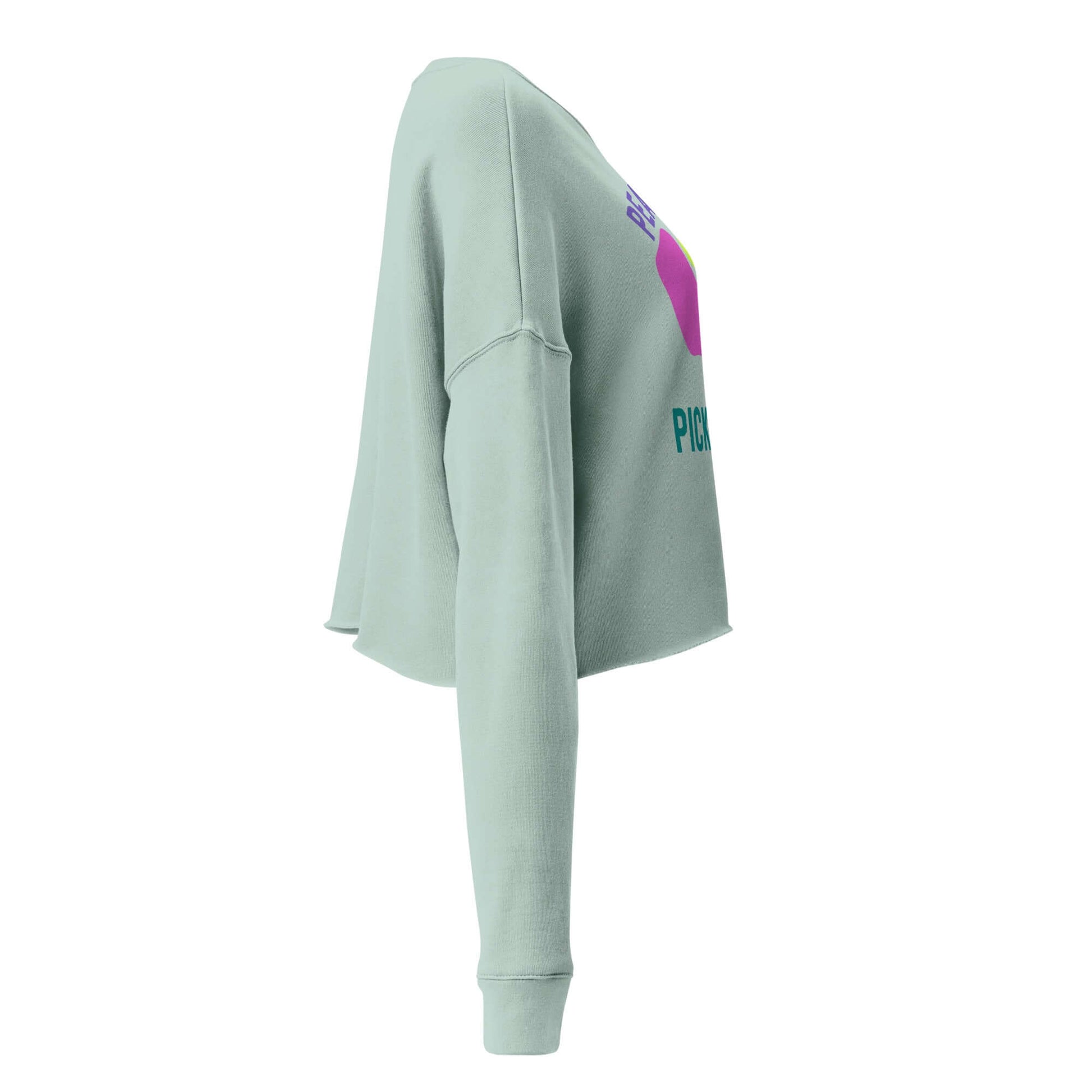 Side view of Women's Peace, Love, Pickleball Crop Sweatshirt in light green, showcasing trendy design and comfortable fit.