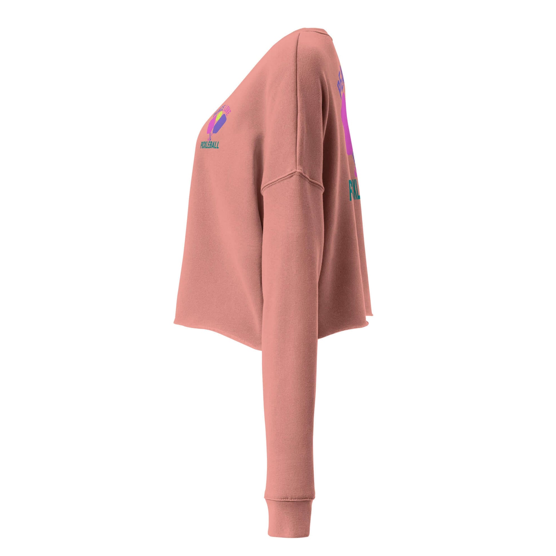Side view of Women's Peace, Love, Pickleball Crop Sweatshirt in soft rose color, showcasing trendy design and comfortable fit.