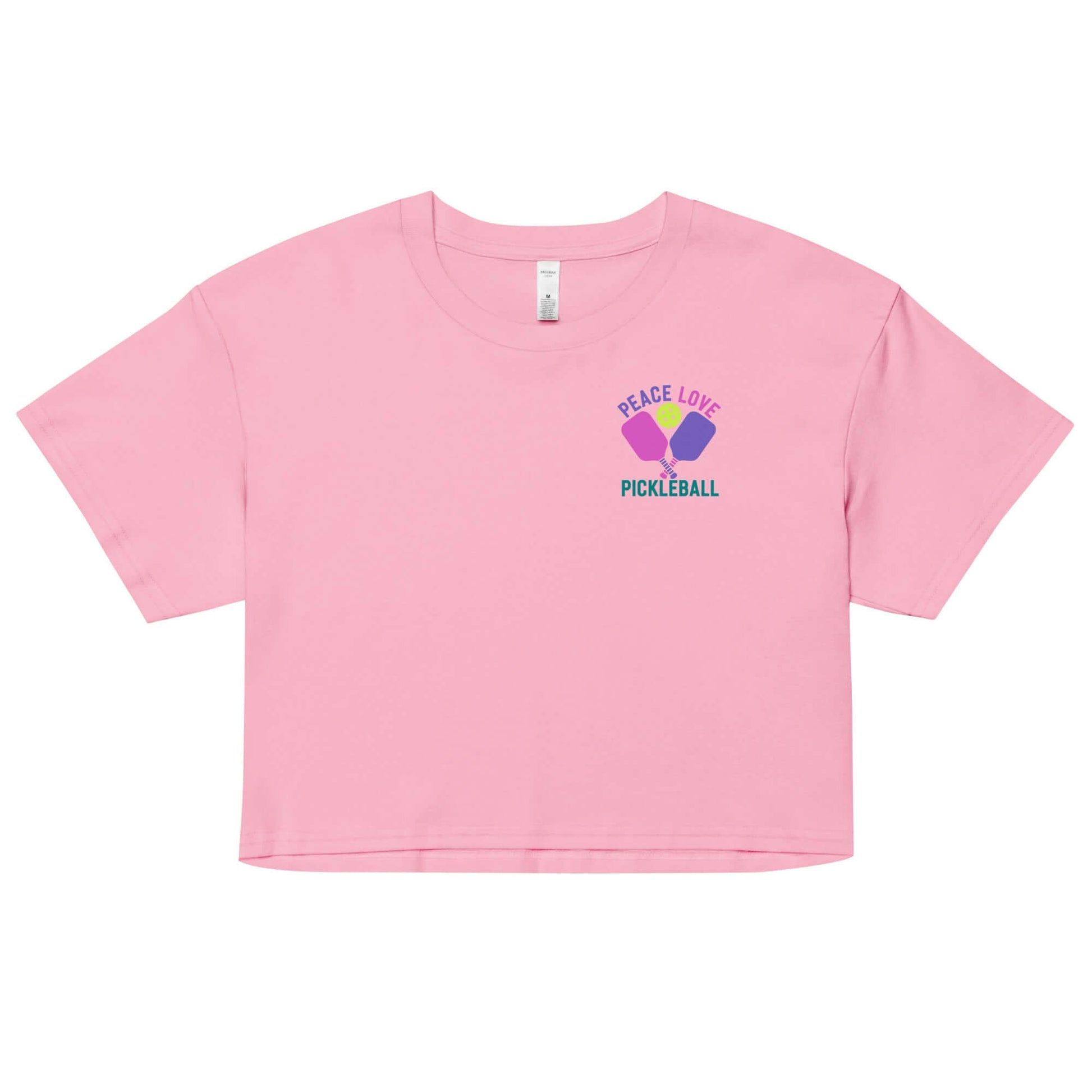 Women's pink crop top with 'Peace Love Pickleball' graphic, perfect for stylish pickleball enthusiasts.