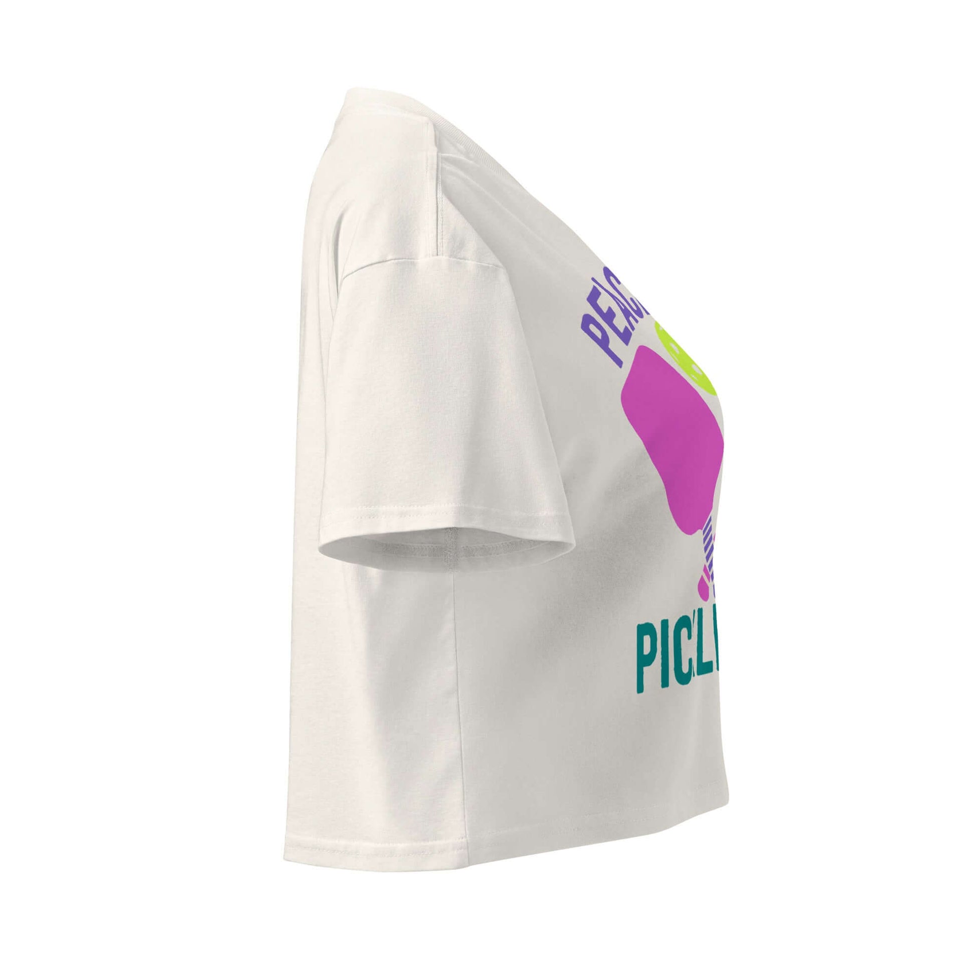 Side view of Women's Peace, Love, Pickleball Crop Top in white with colorful graphic design.