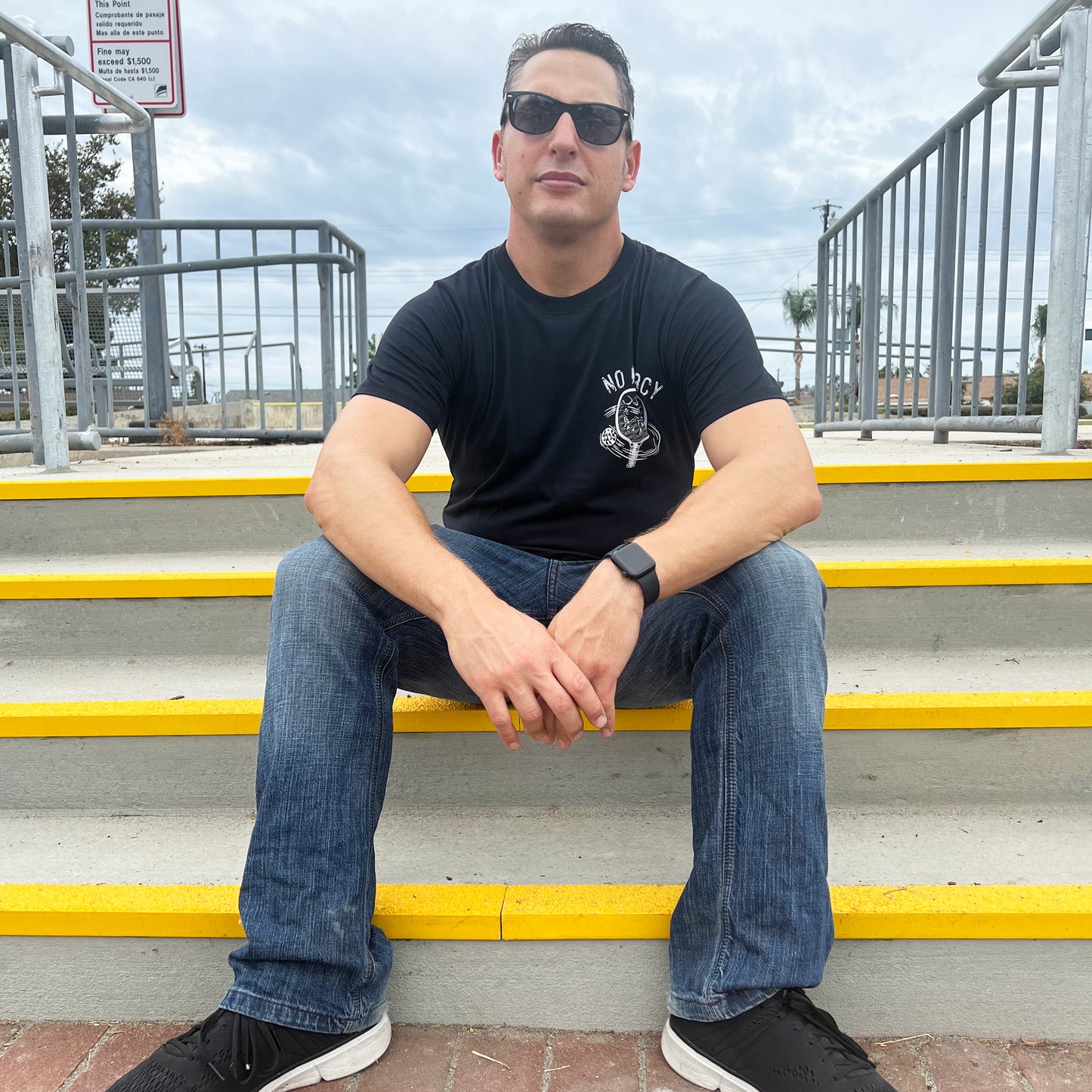 No Mercy Pickleball T-Shirt - Sitting on the steps at the train station