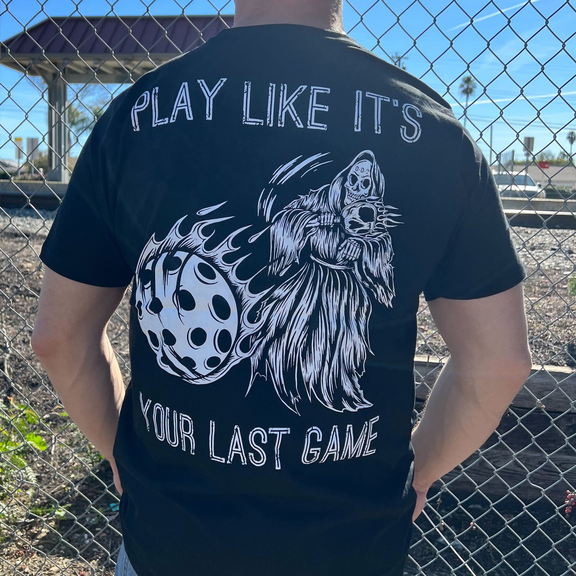Pickleball Shirt - Play like It's Your Last Game - Back Angle in front of a fence